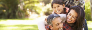 Family lying on grass in countryside