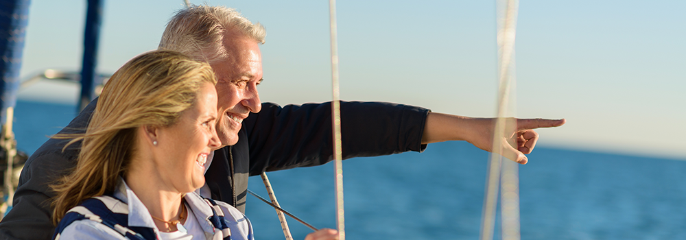 Couple Sailing at Sea and Pointing at Something