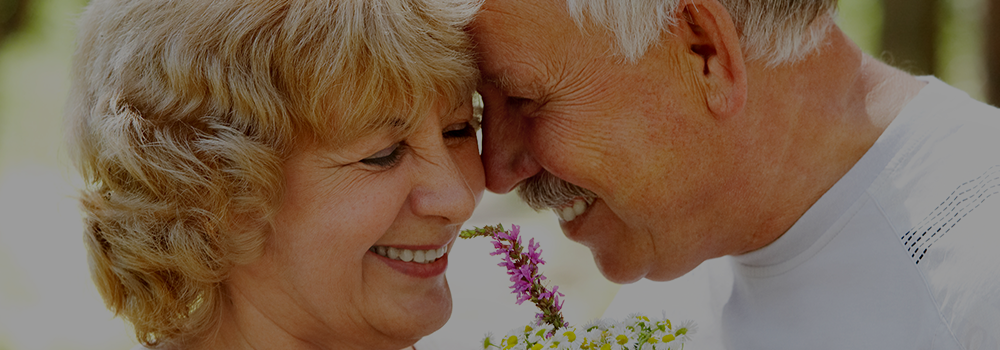 Older Couple Laughing Close To Eachother