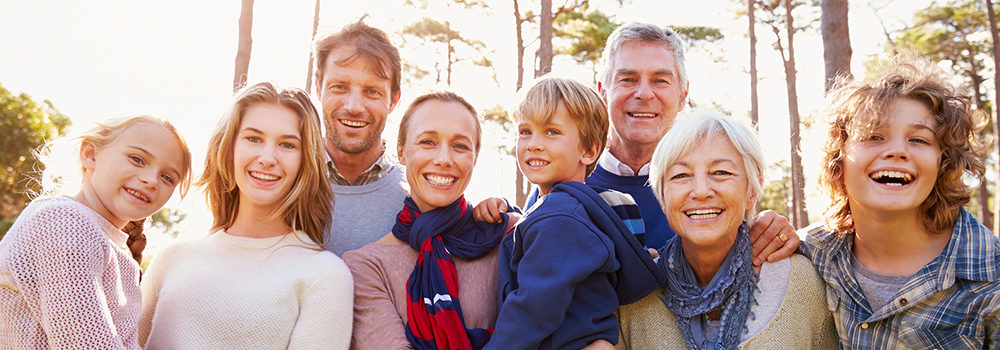 Family Smiling and Laughing in front of Trees